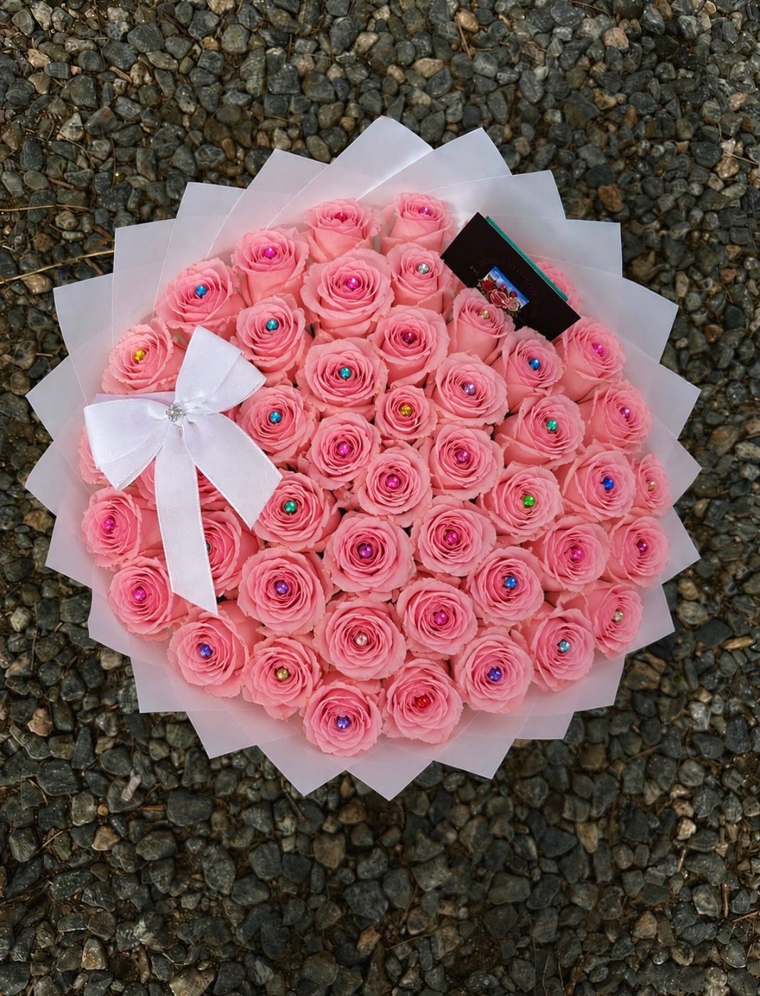 Fifty pale-pink roses set with crystal gems in a white pleated wrap